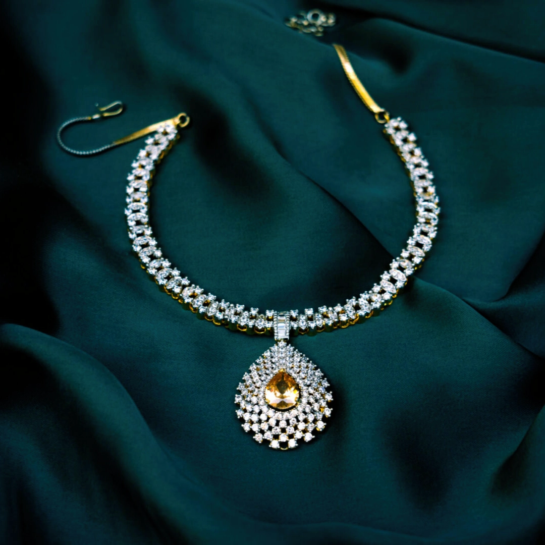 Gold diamond necklace with yellow teardrop pendant
