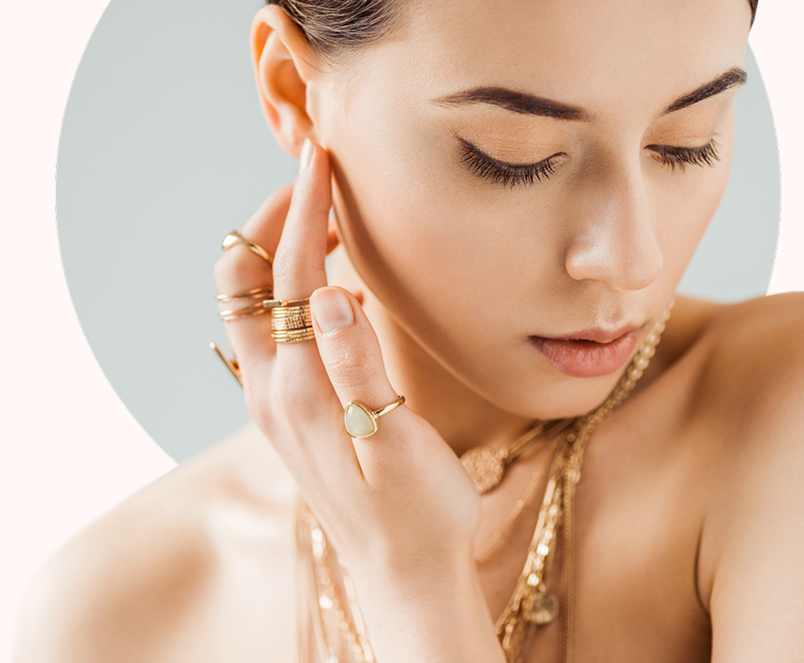 Close-up of woman accessorized with gold jewelry