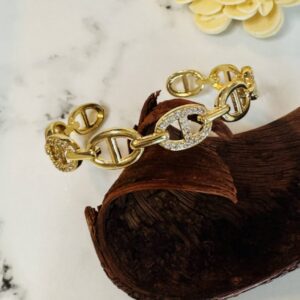 Gold chain bracelet with rhinestone oval links