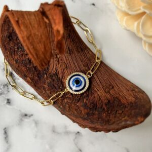 Gold bracelet with blue evil eye charm