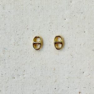 Two gold soda can pull tabs on fabric