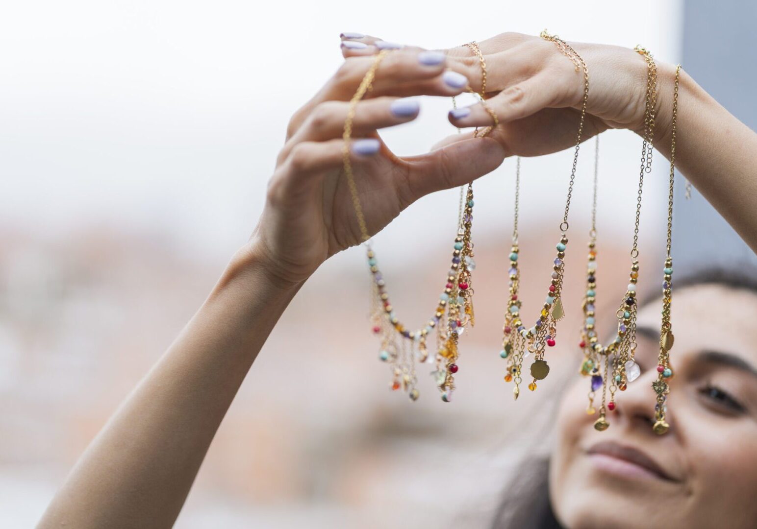 Woman displaying handmade jewelry